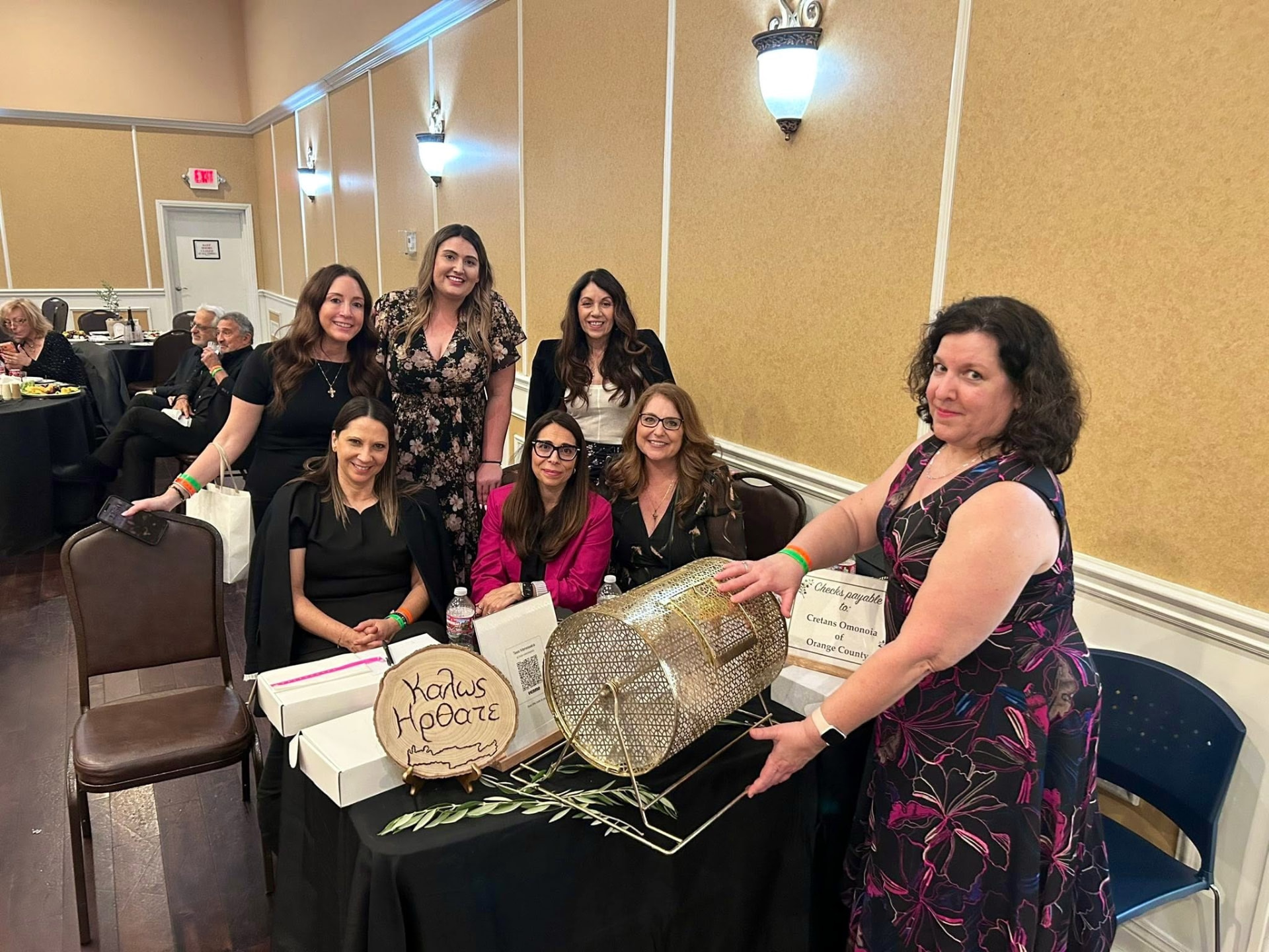 Members posing beside a raffle table at a chapter banquet