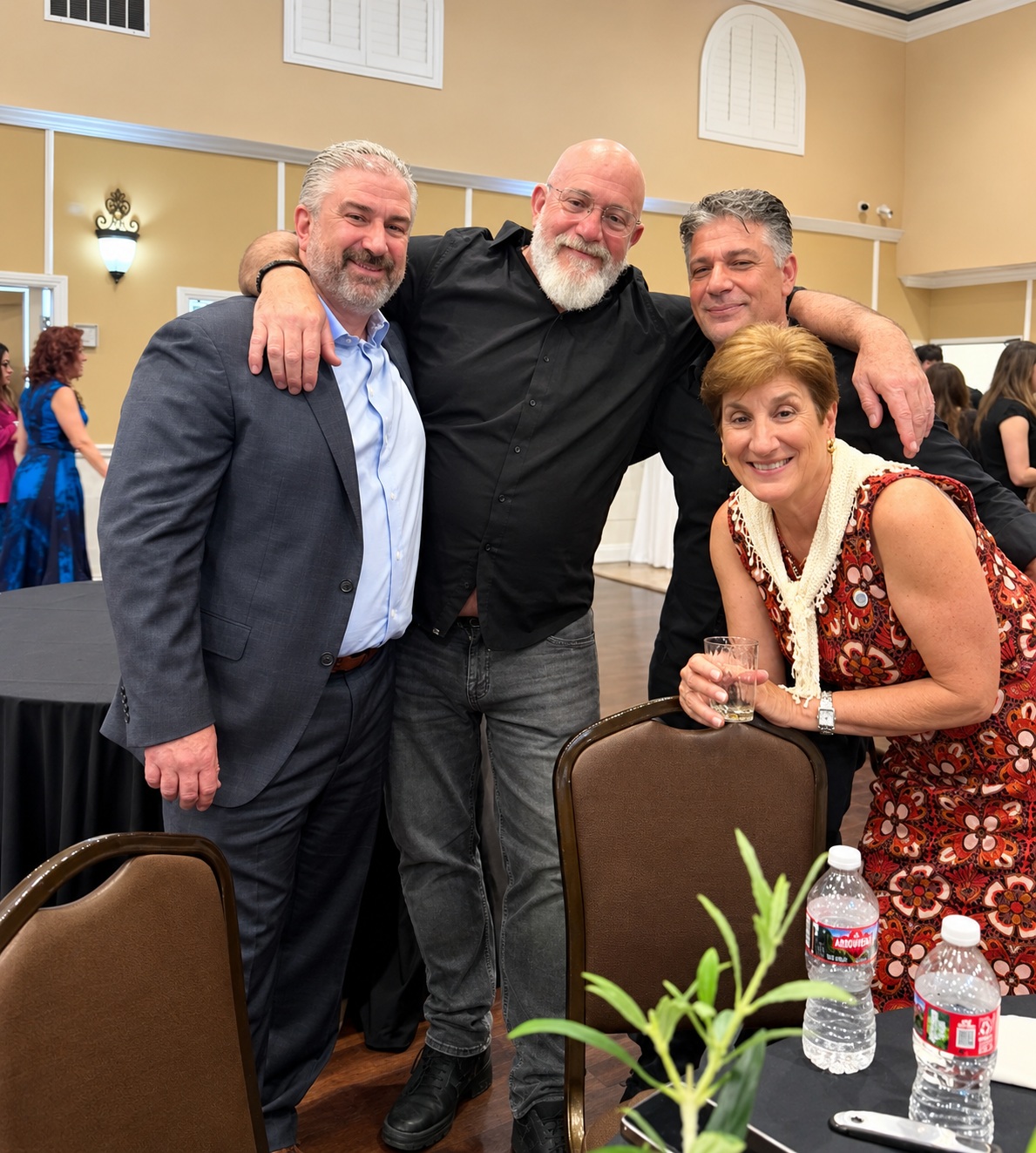 Four members posing together at a banquet reception