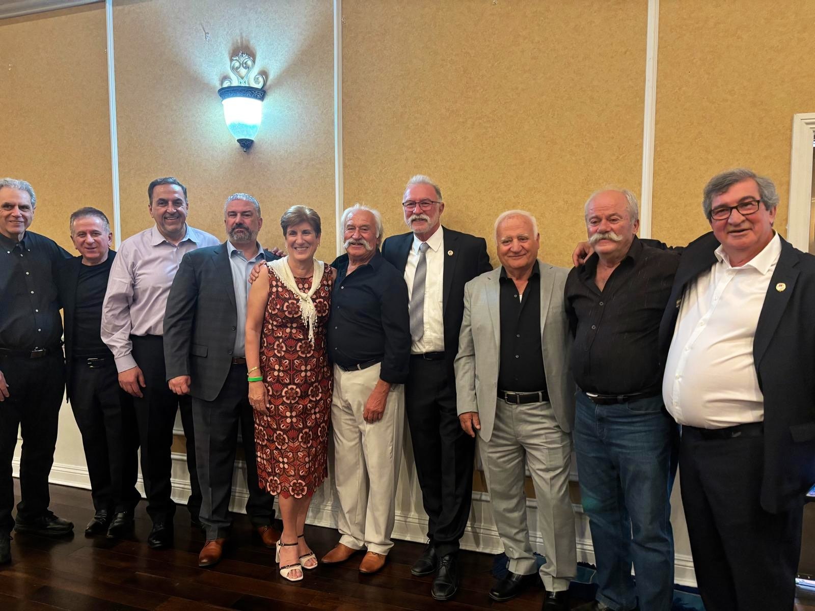 Members in formal attire posing together at a chapter reception